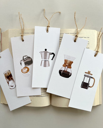 Set of coffee-themed bookmarks hanging from an open book