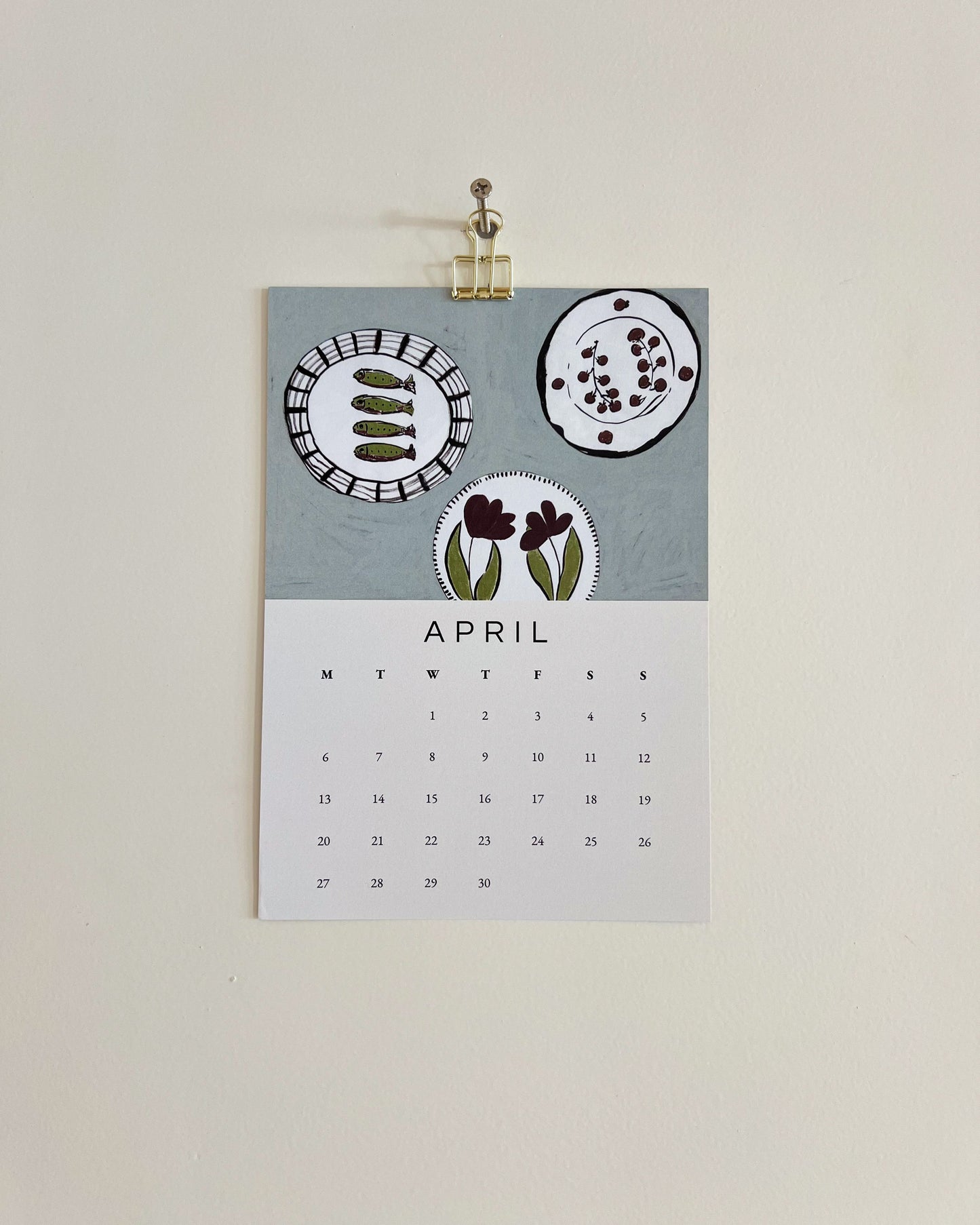 2026 Wall/Desk Calendar with April sketchbook original art/illustration of fishes and plates that represents the start of summer with a summer blue background.