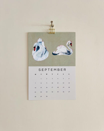 2026 Wall/Desk Calendar with September sketchbook original art/illustration of two swans with a green background.