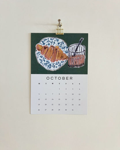 2026 Wall/Desk Calendar with October sketchbook original art/illustration of a croissant and vietnamese coffee in oil pastels.