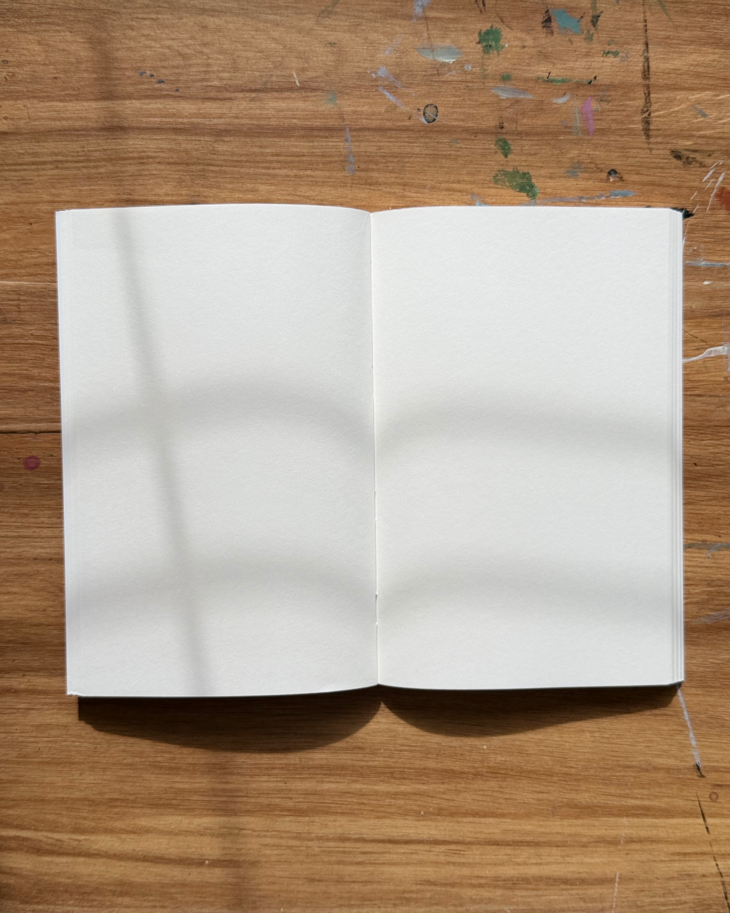 Flat lay blank notebook / sketchbook with white pages 