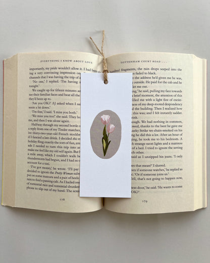 Open book with a bookmark featuring a tulip illustration on a gray background